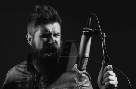 Photo for Karaoke singer. Man singing with music microphone - Royalty Free Image