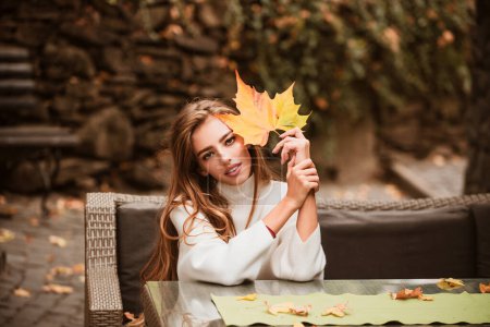 Foto de Belleza mujer disfrutar del otoño. Hojas cayendo y concepto de la gente. Clima cálido y soleado - Imagen libre de derechos
