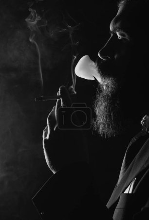 Photo for Man smoking cigarette. Cigarette smoke on black background. Smoker business man - Royalty Free Image