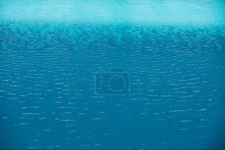 Photo for Water background. Blue water, ripples and highlights. Texture of water surface and tiled bottom - Royalty Free Image