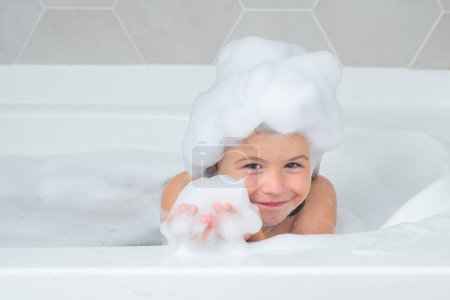 Photo for Soap on child head. Child face in foam. Child with shampoo foam and bubbles on hair taking bath. Portrait of smiling kid, hair care and hygiene. Kids shampoo for long hair. Washing hair in bath - Royalty Free Image