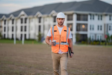 Photo for Portrait of builder in a construction site. Builder ready to build new house. Construction builder wear building uniform and helmet, builder on buildings construction background - Royalty Free Image