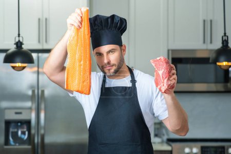 Photo for Portrait of chef man hold fish and meat, salmon and beef in a chef cap in the kitchen. Man wearing apron and chefs uniform and chefs hat. Raw meat beef and fish salmon fillet. High protein diet - Royalty Free Image