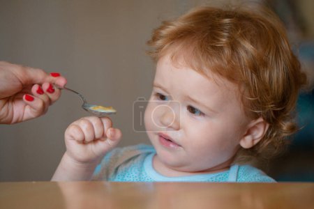 Photo for Feeding baby. Not hungry. Kid refusing to eat. Child have no appetite. Upset little kid refuse to eat soup. Healthy nutrition for kids - Royalty Free Image