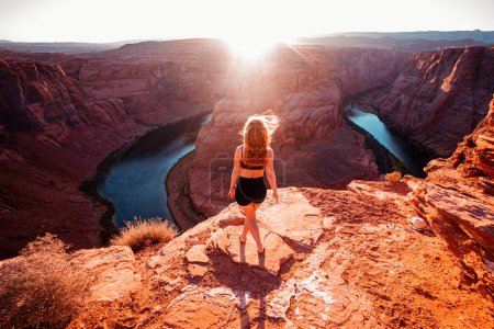 Photo for Tourist woman. Carefree woman on Grand canyon, Glen Canyon, Arizona. Woman enjoying view of Horseshoe bend, Arizona - Royalty Free Image