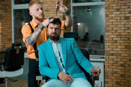 Photo for Razor blade. Barber - Shaves and Trims. Hairdressers work for a handsome guy at the barber shop. Hair Preparation is just for the dashing chap. Bearded client visiting barber shop - Royalty Free Image