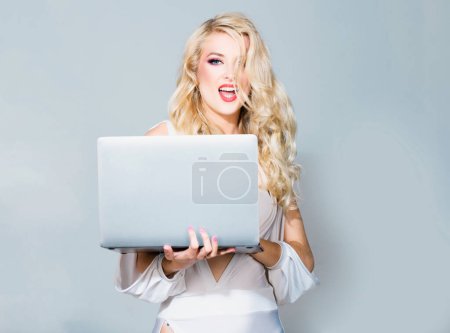 Photo for Sexy secretary. Beauty blonde woman using laptop computer isolated background - Royalty Free Image