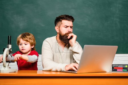 Photo for School children. Happy family. Back to school. Concept of education and teaching. Young or adult. Teacher and schoolboy using laptop in class. Homeschooling. Childhood and parenthood - Royalty Free Image