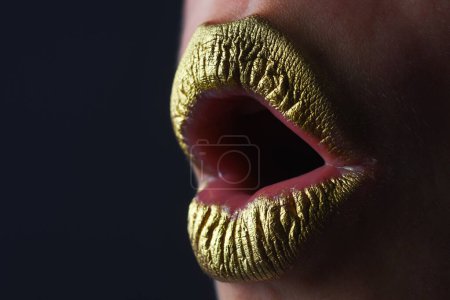 Photo for Woman plump lips with gold. Golden glitter lipstick. Shine style for sexy lip. Sensual woman lips. Luxury golden mouth. Glamour gold lips. Golden lips with golden paint or metallic lipstick - Royalty Free Image