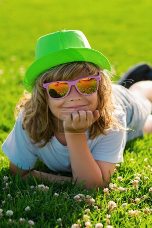 Photo for Kid summer. Happy child enjoying on grass field and dreaming. Summer dream. Kid dreams on grass. Childhood dream. Daydreamer child. Dreams and imagination. Dreamy kids face - Royalty Free Image