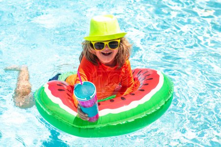 Téléchargez les photos : Enfants jouant dans la piscine. Activité estivale. Enfant nager au bord de la piscine dans l'eau de fond - en image libre de droit