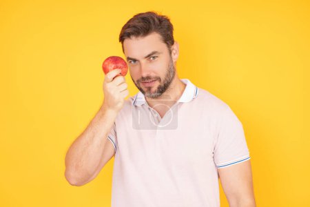 Photo for Stomatology concept. Man with perfect smile holding apple on yellow studio isolated background. Man eat green apple. Portrait of middle aged man with apples. Healthy diet food - Royalty Free Image