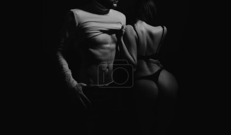 Photo for Romantic couple. Attractive macho booty girl passionate lovers. Sexy girl muscular guy in darkness. Romantic passionate relations. Love and sex. Seduce him. Intimate atmosphere. Passionate lovers. - Royalty Free Image