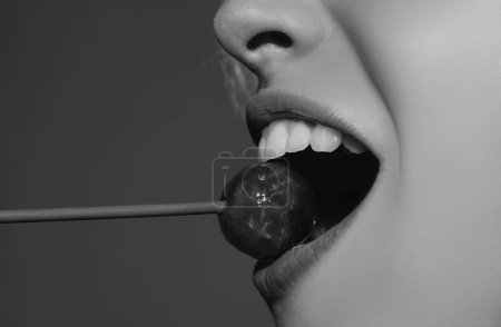 Photo for Close up lips with lollipop isolated, sexy blowjob, sensual mouth with lipstick eats sweets. Sexy design for women and girls. Beautiful lips - Royalty Free Image