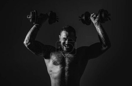 Photo for Brutal sportsman with barbell. steroids. confidence charisma. sexy abs of tattoo man. male fashion. muscular macho man with athletic body. sport and fitness. dumbell lifting. training with coach. - Royalty Free Image