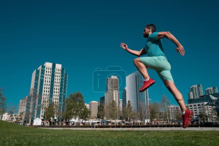Photo for Man running outdoors on the town. Jogging in a city park - Royalty Free Image