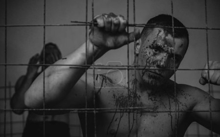 Photo for Murderer mythical creature. Halloween concept. Scary monster just murdered his victim. Strong aggressive monster behind grid. Muscular man nude torso soiled blood. Prison for monster. Psycho mad man. - Royalty Free Image