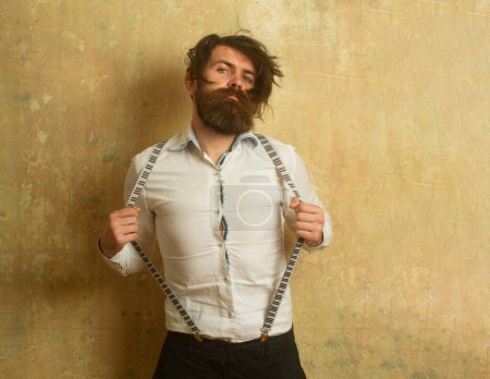 Photo for Funny crazy guy man his suspenders feel candid face expression. Bearded man with uncombed disheveled hair - Royalty Free Image