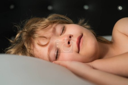 Photo for Smiling kids sleeping in bed. Sweet dreams. White pillow. Little angel dreams. Sleep dream. Dreamy kids face. Daydreamer child portrait close up. Dreams and imagination - Royalty Free Image