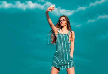 Photo for Jeans overalls. Fashion trendy street style. Sexy girl woman in sunglasses, Denim clothes - Royalty Free Image