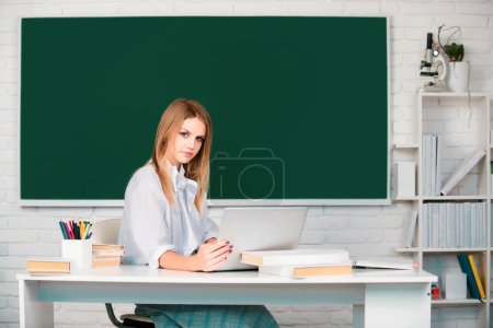 Photo for Portrait of a young, confident and attractive female student studying in school classroom. Successful female student at classroom of university - Royalty Free Image