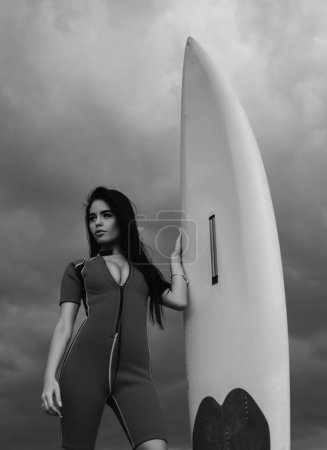 Photo for Sexy surfer girl with white surfboard. Lifeguard on beach - Royalty Free Image
