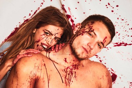 Foto de Raw meat, halloween couple in blood. Meatman in butcher shop. Piece of meat. Bloody face - Imagen libre de derechos