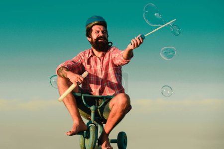 Photo for Childhood memory. Funny crazy man riding a bike - Royalty Free Image