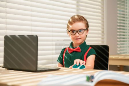 Photo for Online remote learning. School kids with computer having video conference chat with teacher in class. Child studying at home. Homeschooling concept - Royalty Free Image