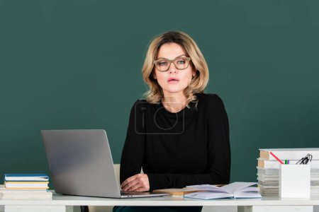 Photo for Teachers day. Teacher in classroom at university or college. Female student on board with computer laptop. Lesson seminar skills. Young woman study in high school - Royalty Free Image