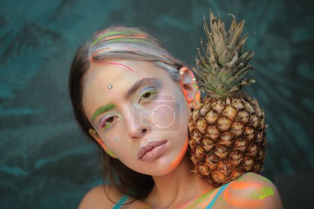 Photo for Beauty summer makeup. Abstract make up. Vogue style. Woman with pineapple fruit. Summertime mood - Royalty Free Image