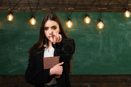 Photo for Student life. Young attractive teacher pointing at chalkboard. Teenager school. Teenager school - first love. Back to school and home schooling. School concept. Your text on Blackboard - Royalty Free Image