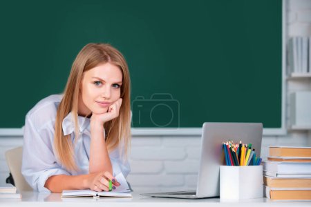 Photo for Portrait of female university student study lesson at school or university. Student education concept. Smiling girl or teacher portrait on blackboard background - Royalty Free Image