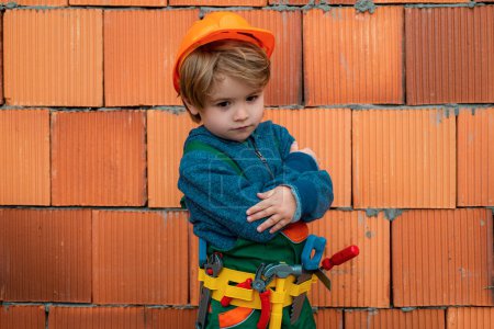 Photo for Child construction worker. Little boy to use Carpenter tools and hammering - Royalty Free Image