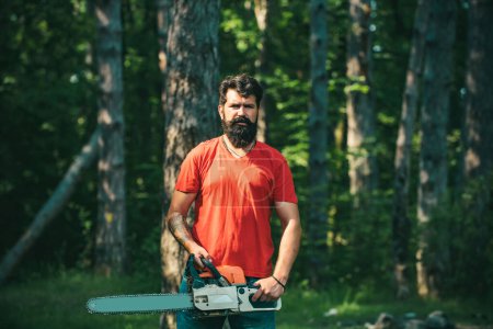 Photo for Lumberjack with chainsaw in his hands. Chainsaw. Deforestation is a major cause of land degradation and destabilization of natural ecosystems - Royalty Free Image