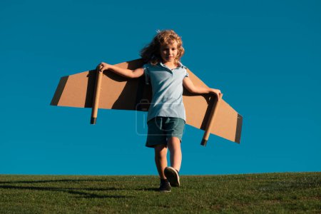 Photo for Freedom carefree and kids dream. Kid dreams of future. Kid pilot dreaming. Child dream concept. Blonde cute daydreamer child dream on fly. Dreams and imagination. Creative kid dreaming of fly - Royalty Free Image