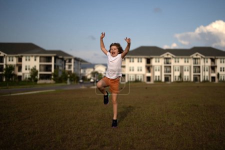 Photo for Excited kid boy running on green grass background, panoramic banner. Child running outdoor. Healthy sport activity for children. Little boy at athletics competition race. Runner kids exercising - Royalty Free Image