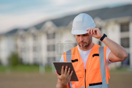Photo for Engineer with tablet, building inspection. Construction man in helmet build new house. Engineer work in builder uniform and hard hat. Foreman outdoor portrait. Hispanic engineer builder - Royalty Free Image