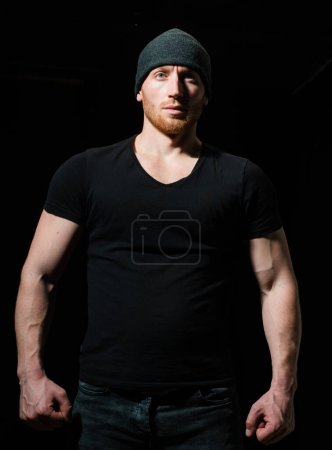 Photo for Brutal angry gang man lifestyle, serious handsome guy on black - Royalty Free Image