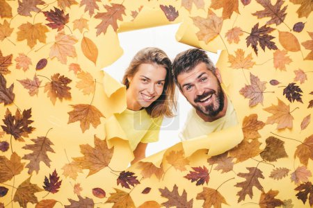 Photo for Autumn couple wearing in autumn clothes and looks very sensually. Romantic couple wearing pullover on autumn leaves background. Joyful couple is happy with the last warm days of autumn - Royalty Free Image