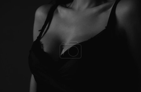 Lingerie concept. Sexy breas, boobs in bra, sensual tits. Beauty slim female body. Closeup of sexy girl boob in black bra