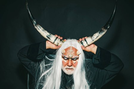 Photo for Magic and fairy tale concept. Man evil with horns. Monster with sharp thorns and warts on face. Mysterious warrior enchanted to have thorns on his face. Demon with bloody horns on head - Royalty Free Image