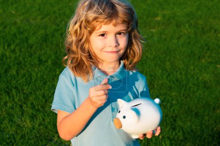 Photo for Portrait of cute little boy with piggy bank. Saving money concept. Kids with piggybank money box - Royalty Free Image