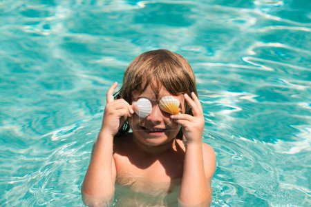 Photo for Child in swimming pool playing in water. Vacation and traveling with kids. Children play outdoors in summer. Covered eyes with shells - Royalty Free Image