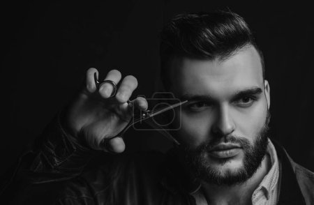 Photo for Young sexy man, portrait of guy with barber scissors for barber shop. Modern barbershop, shaving. Handsome male with modern hairstyle on black - Royalty Free Image