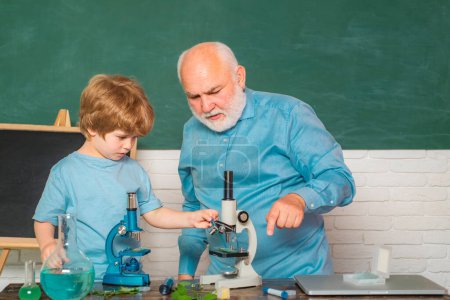 Photo for Learning and education concept. Knowledge day. Microbiology science. Pupil studying in the classroom. Old bearded teacher in the classroom - Royalty Free Image