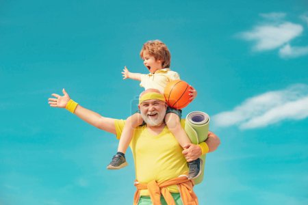 Photo for I love sport. Healthy family lifestyle. Elderly sporty man and young boy sporting morning workout - copy space. Rehabilitation. Grandfather and son doing exercises - Royalty Free Image
