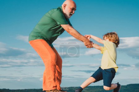 Photo for Grandfather helping hand. Child rearing. The educative process needs to begin early in a childs life. Often the childs misbehavior is simply an attempt to cope with some other problem - Royalty Free Image
