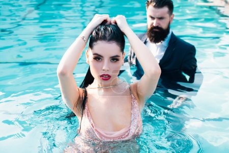 Photo for Celebrity couple, fashionable pair of elegant people. Romantic couple on Party in swimming pool. Concept of relations fashion beauty and love - Royalty Free Image