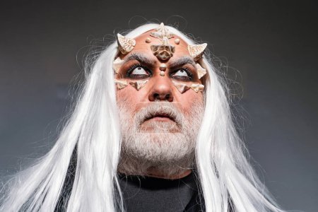 Photo for Bearded old man dressed like Halloween monster. Wizard demon man with dragon skin and horns. Man evil with horns. Alien with dragon skin and grey beard. Devil horns - Royalty Free Image